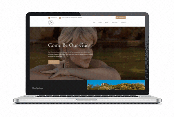 Laptop screen showing the Hacienda Camino del Real website with a historic interior image and homepage design.